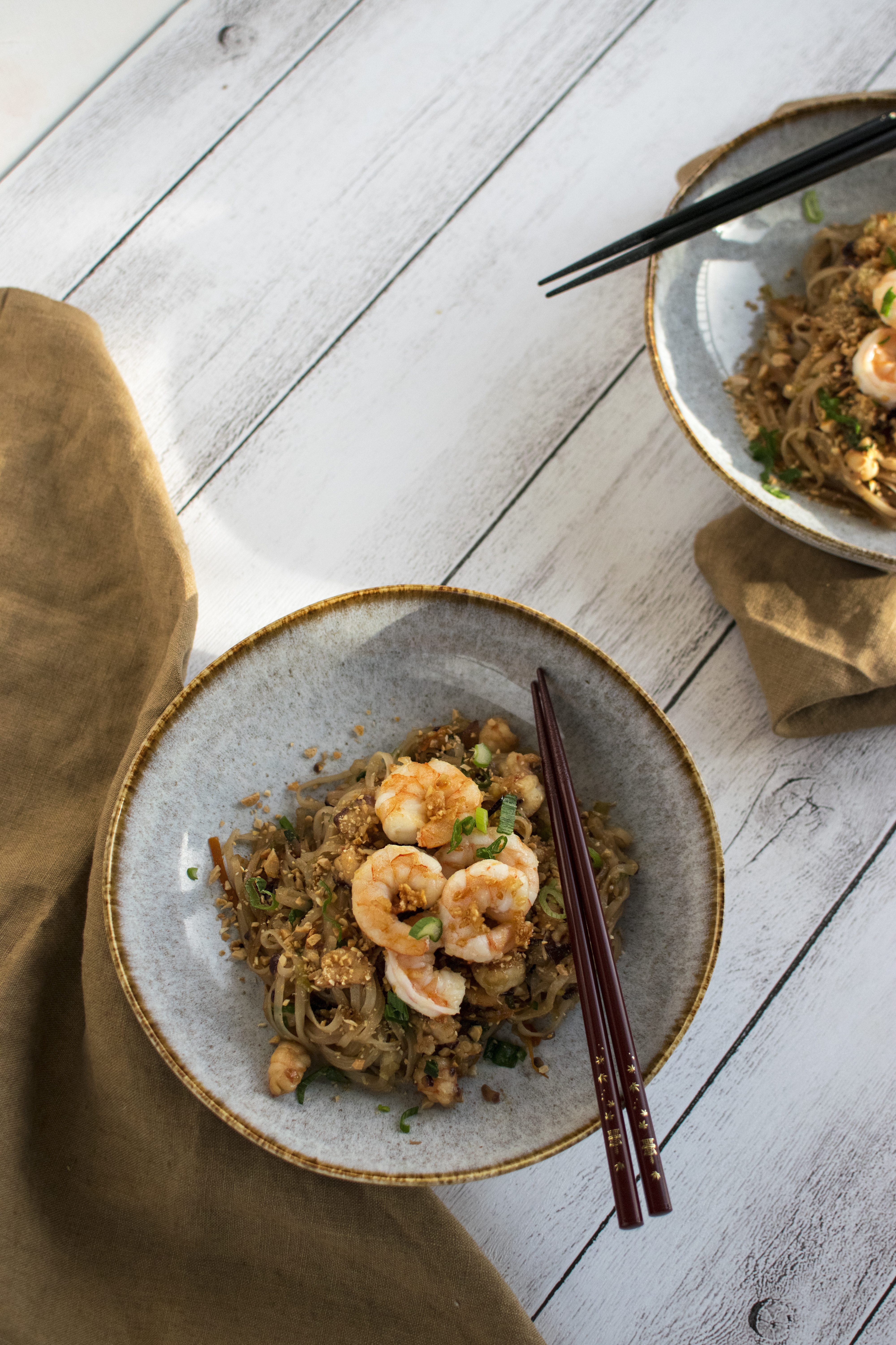 Shrimp  Pad Thai made with rice noodles, tamarind sauce, shrimps, carrots, onions, a sprinkle of peanuts. 