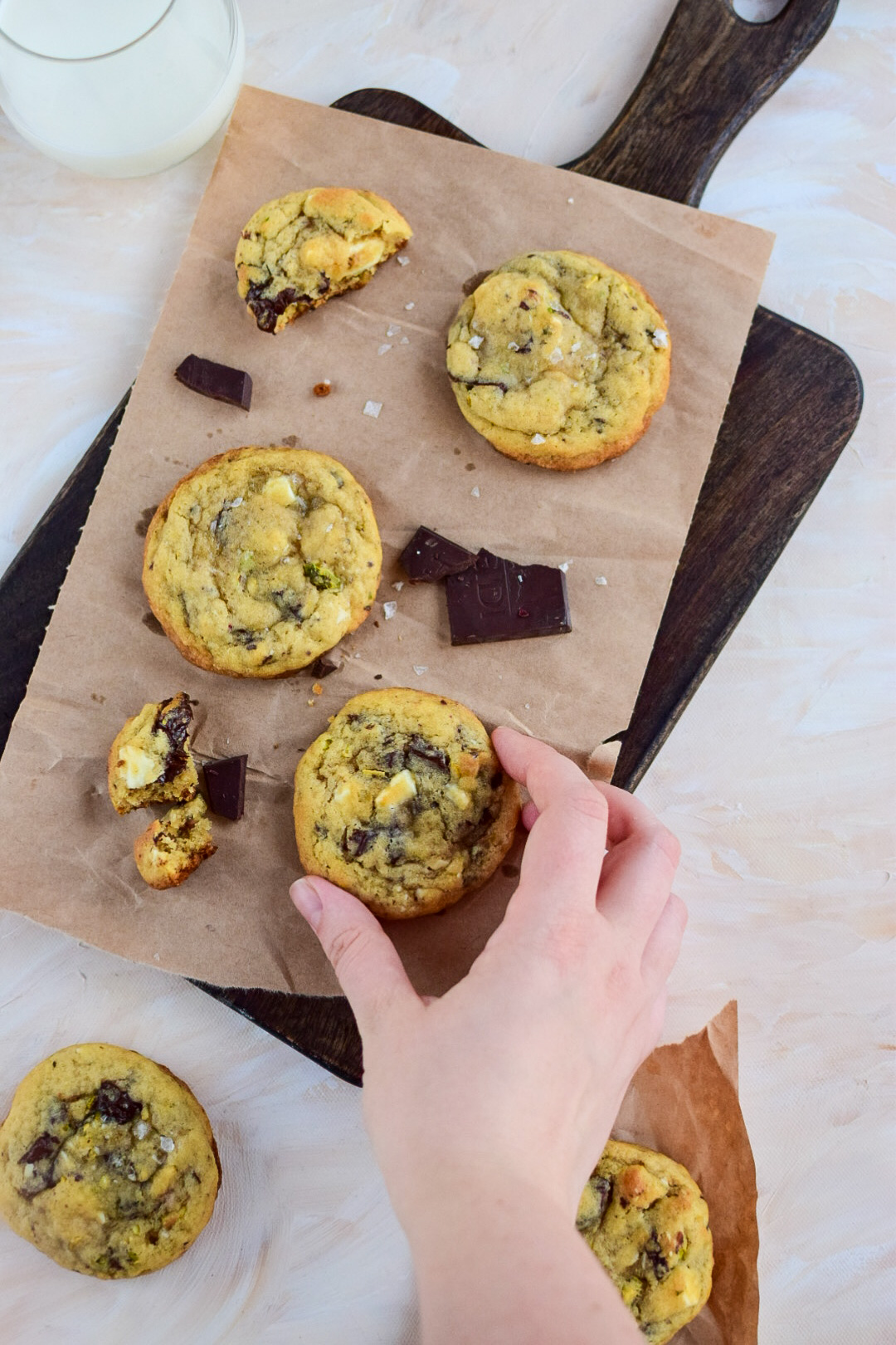 Chocolate cookies on brown paper, with a glass of milk